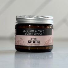 Jar of Mountain Time Soap & Supply Better Body Butter on a white surface with a neutral background