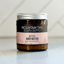 Jar of body butter with 'Mountain Time Soap & Supply' label on a light background
