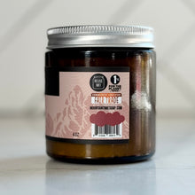 Jar of body butter with a fair trade label on a light background