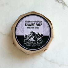 Shaving soap bar with a mountain-themed label on a marble surface