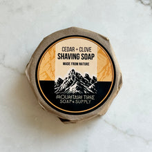 Shaving soap container with 'Mountain Time Soap & Supply' label on a marble surface